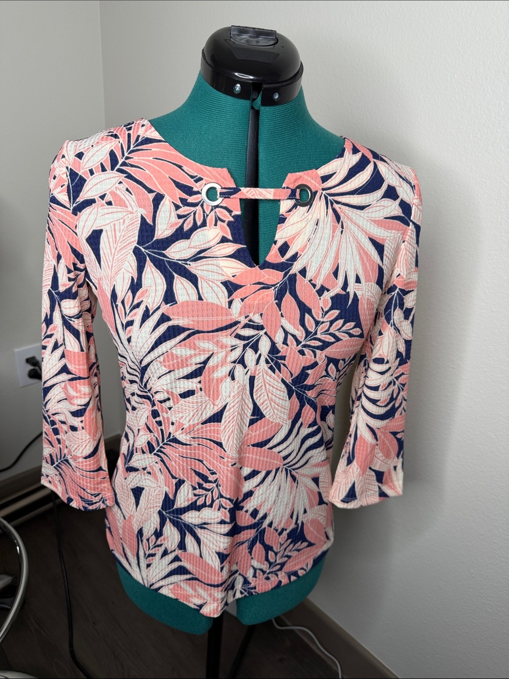 Emily Daniel’s pink, blue, and white floral blouse top with 3/4 sleeves